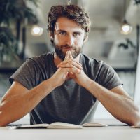 pensive-business-man-sitting-at-his-working-table-2021-09-02-22-28-21-utc.jpg